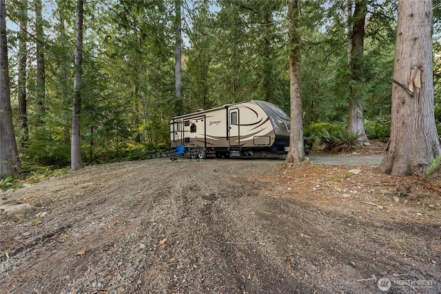 76 Thompson Point Rd, Port Angeles, WA 98363 - view of car parking featuring a wooded view