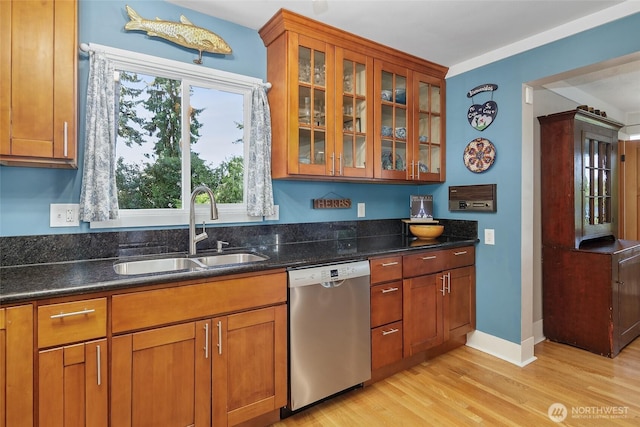 23619 74th Ave W, Edmonds, WA 98026 - kitchen featuring dishwasher, a sink, brown cabinets, light wood-type flooring, and glass insert cabinets
