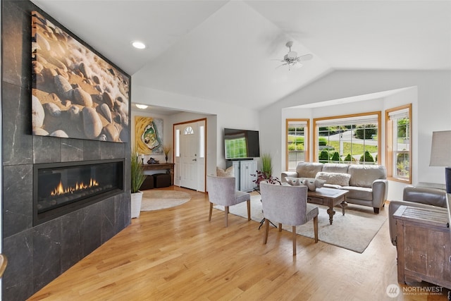 37401 Olympic View Rd NE, Hansville, WA 98340 - living area with a tile fireplace, wood finished floors, vaulted ceiling, ceiling fan, and recessed lighting
