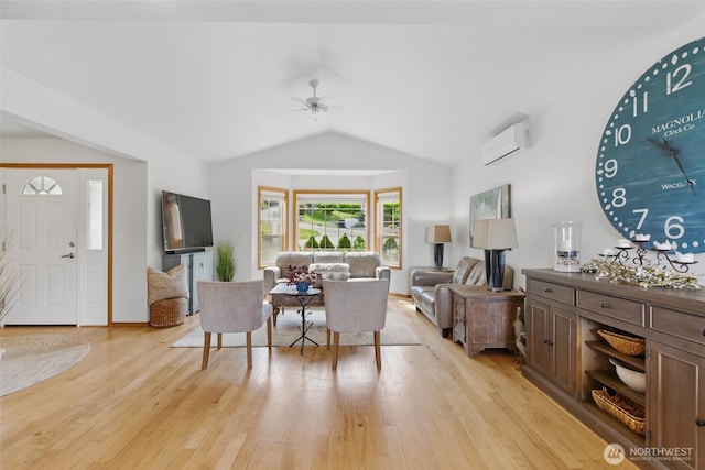 37401 Olympic View Rd NE, Hansville, WA 98340 - living room with a wall mounted AC, vaulted ceiling, light wood-style floors, and ceiling fan