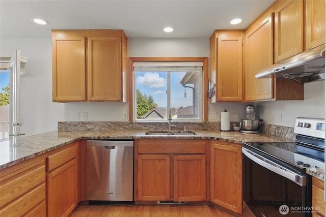 37401 Olympic View Rd NE, Hansville, WA 98340 - kitchen with stainless steel appliances, under cabinet range hood, a sink, light stone countertops, and light wood-style flooring