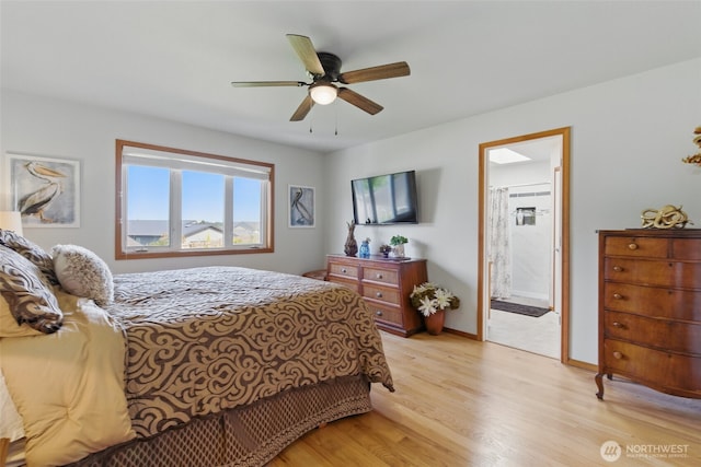 37401 Olympic View Rd NE, Hansville, WA 98340 - bedroom with light wood-type flooring, a ceiling fan, baseboards, and ensuite bath