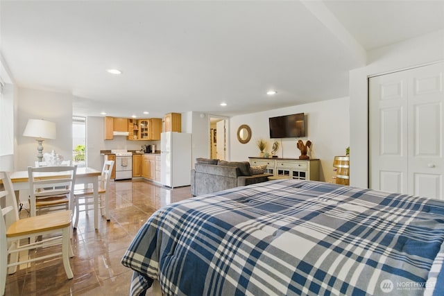 37401 Olympic View Rd NE, Hansville, WA 98340 - bedroom featuring freestanding refrigerator, recessed lighting, and light marble finish flooring