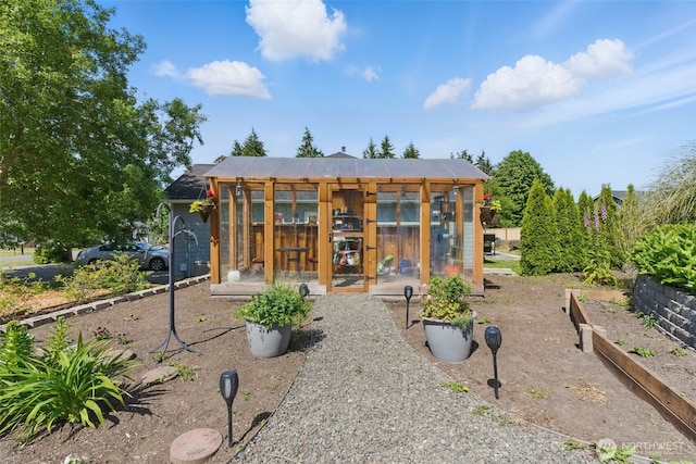 37401 Olympic View Rd NE, Hansville, WA 98340 - rear view of house featuring an exterior structure, a vegetable garden, and an outbuilding