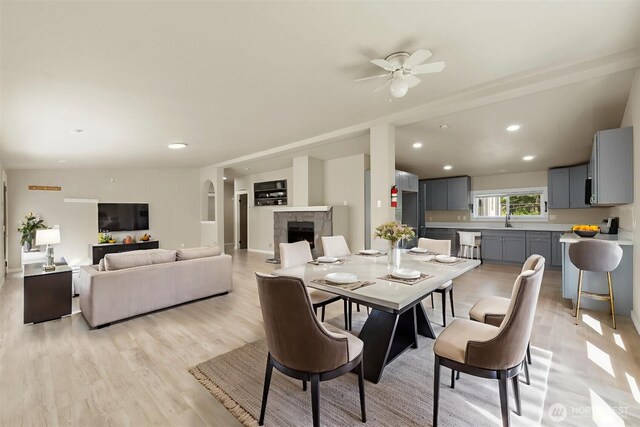 20119 120th Ave E, Graham, WA 98338 - dining room with a ceiling fan, a fireplace, light wood-type flooring, and recessed lighting