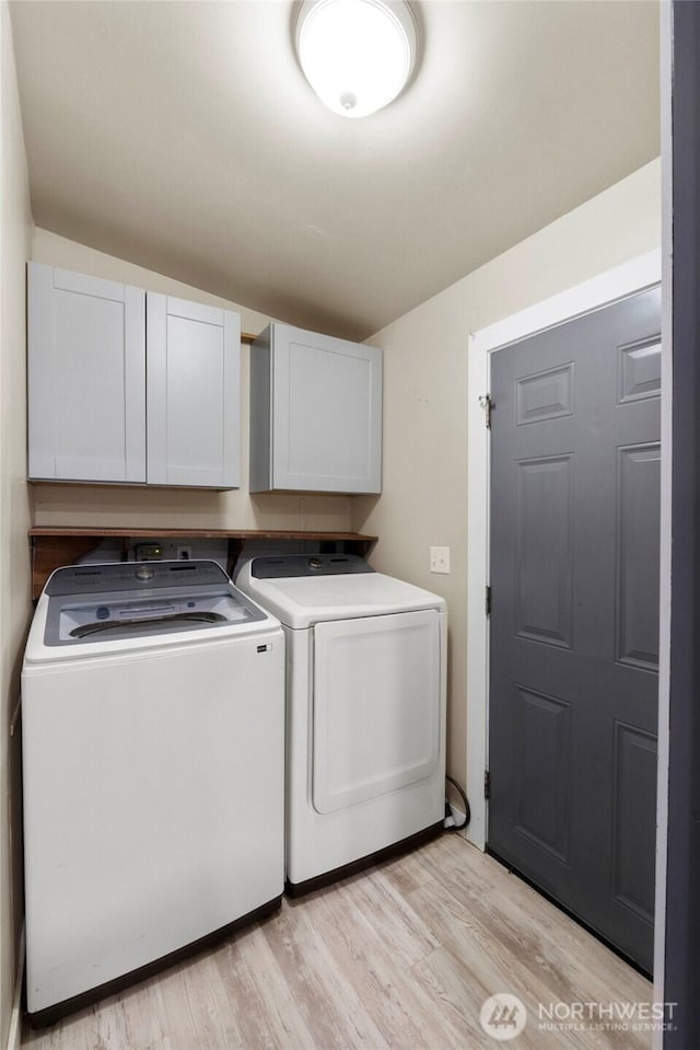 20119 120th Ave E, Graham, WA 98338 - washroom with separate washer and dryer, cabinet space, and light wood-style floors