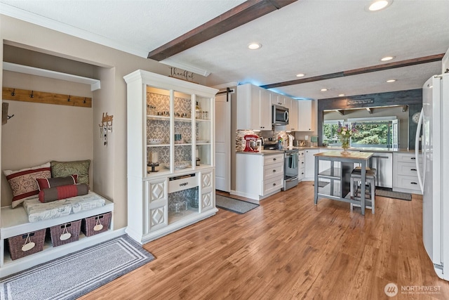 1598 Tedford St SE, East Wenatchee, WA 98802 - kitchen featuring stainless steel appliances, white cabinets, recessed lighting, light wood-style floors, and light countertops