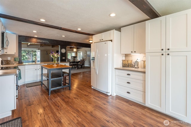 1598 Tedford St SE, East Wenatchee, WA 98802 - kitchen with white appliances, beam ceiling, recessed lighting, white cabinets, and dark wood finished floors