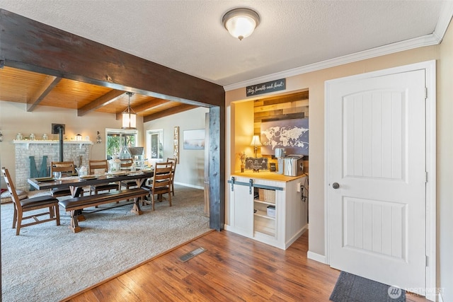 1598 Tedford St SE, East Wenatchee, WA 98802 - dining area featuring wood finished floors, beamed ceiling, a textured ceiling, and crown molding