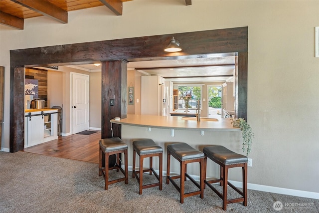 1598 Tedford St SE, East Wenatchee, WA 98802 - kitchen with carpet, beamed ceiling, and a breakfast bar area