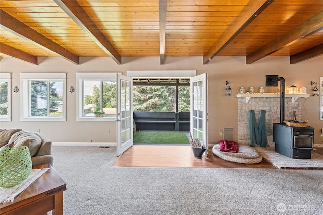 1598 Tedford St SE, East Wenatchee, WA 98802 - living room with carpet flooring, beam ceiling, a wood stove, plenty of natural light, and french doors