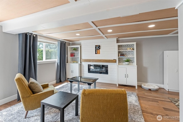 1598 Tedford St SE, East Wenatchee, WA 98802 - living area with wood finished floors, a glass covered fireplace, recessed lighting, and beam ceiling