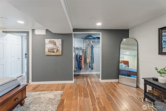 1598 Tedford St SE, East Wenatchee, WA 98802 - bedroom with light wood-style floors, a spacious closet, a closet, recessed lighting, and wood walls
