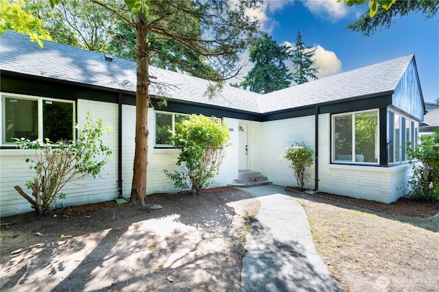 2874 30th Ave W, Seattle, WA 99819 - view of front of home featuring brick siding, a shingled roof, and entry steps