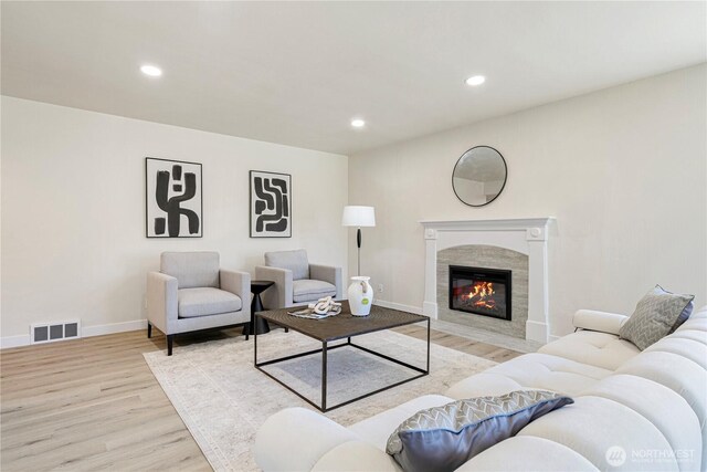 2874 30th Ave W, Seattle, WA 99819 - living area featuring wood finished floors, a tiled fireplace, and recessed lighting