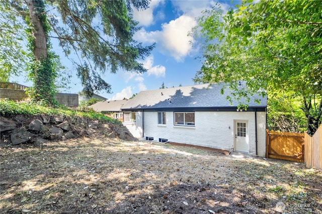 2874 30th Ave W, Seattle, WA 99819 - back of house featuring brick siding and a fenced backyard