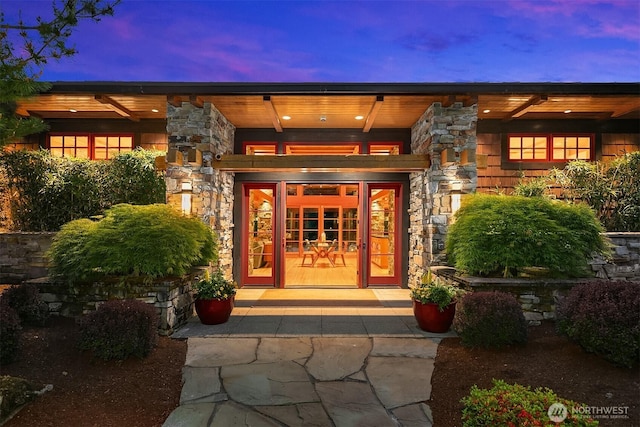 15910 Uplands Way SE, North Bend, WA 98045 - exterior entry at dusk featuring stone siding