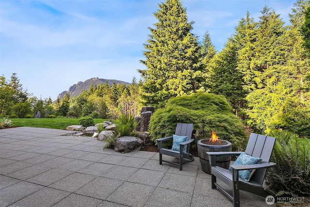 15910 Uplands Way SE, North Bend, WA 98045 - view of patio featuring an outdoor fire pit and a mountain view