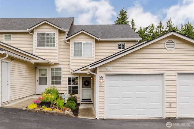 5417 99th Street Ct E, Puyallup, WA 98373 - view of front facade featuring a shingled roof, an attached garage, and asphalt driveway