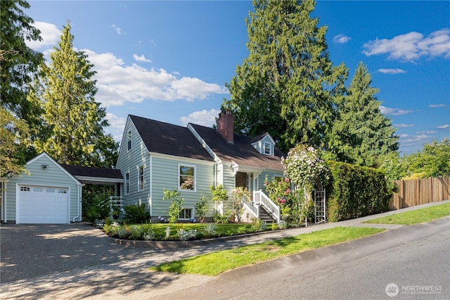 1717 SW Austin St, Seattle, WA 98106 - cape cod house featuring a garage, driveway, a chimney, and an outbuilding