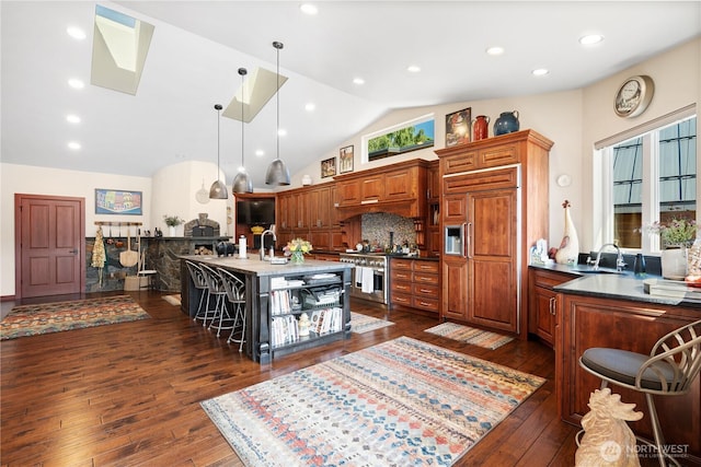 127 Bella Ln, Manson, WA 98831 - kitchen with high end appliances, dark wood finished floors, an island with sink, a sink, and open shelves