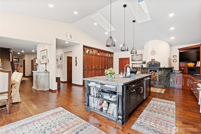 127 Bella Ln, Manson, WA 98831 - kitchen featuring a sink, black microwave, lofted ceiling, dark wood finished floors, and stainless steel dishwasher