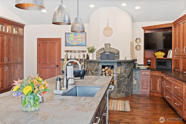 127 Bella Ln, Manson, WA 98831 - kitchen featuring black microwave, dark wood-type flooring, a sink, stainless steel dishwasher, and light stone counters