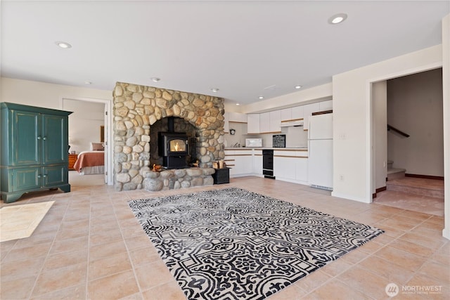 127 Bella Ln, Manson, WA 98831 - living area with light tile patterned floors, stairway, recessed lighting, a wood stove, and baseboards