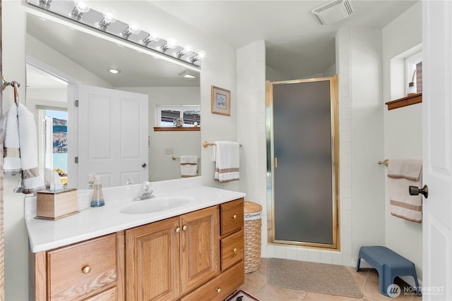 127 Bella Ln, Manson, WA 98831 - full bath featuring vanity, a stall shower, and tile patterned flooring