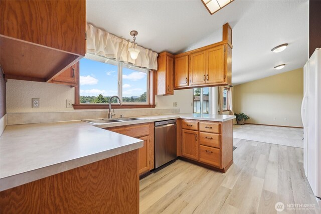 13820 Logez Ct SW, Olympia, WA 98512 - kitchen with stainless steel dishwasher, a sink, a peninsula, lofted ceiling, and freestanding refrigerator
