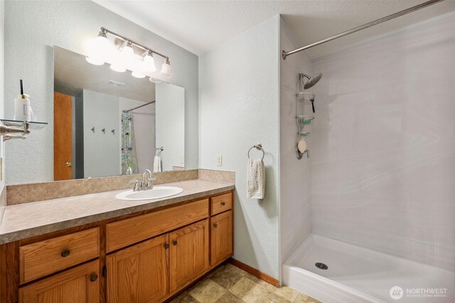 13820 Logez Ct SW, Olympia, WA 98512 - bathroom with a shower with curtain, vanity, and baseboards