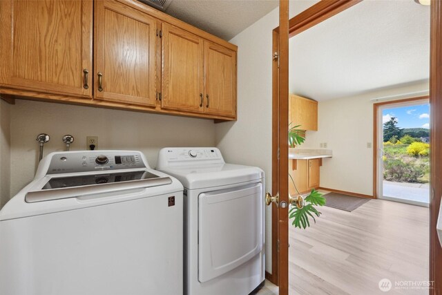 13820 Logez Ct SW, Olympia, WA 98512 - laundry room featuring washing machine and dryer, cabinet space, light wood-style flooring, and baseboards