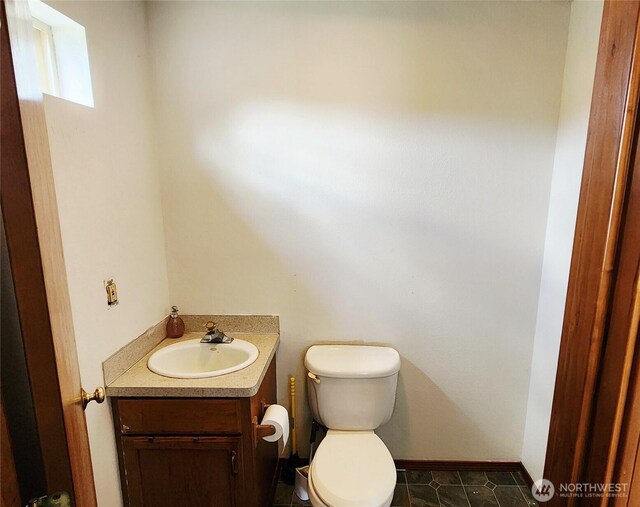 13820 Logez Ct SW, Olympia, WA 98512 - half bathroom featuring toilet, vanity, and baseboards
