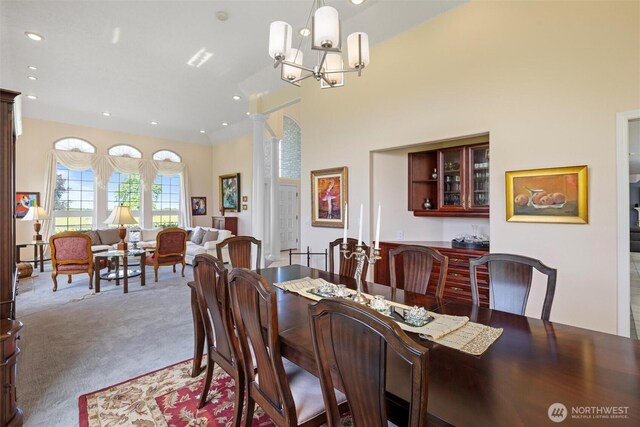 1702 Jb George Rd, Walla Walla, WA 99362 - carpeted dining area featuring ornate columns, a chandelier, recessed lighting, and lofted ceiling