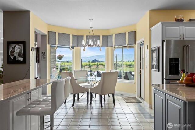 1702 Jb George Rd, Walla Walla, WA 99362 - dining room featuring healthy amount of natural light, a chandelier, baseboards, and light tile patterned flooring