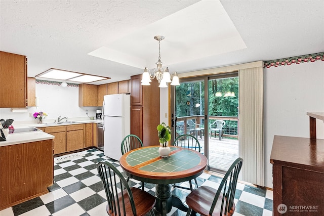 4119 Big Beef Xing NW, Bremerton, WA 98312 - dining area with tile patterned floors, a chandelier, a textured ceiling, and a tray ceiling