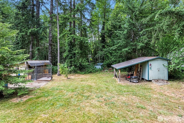 4119 Big Beef Xing NW, Bremerton, WA 98312 - view of green lawn with a storage unit, a wooded view, and a carport