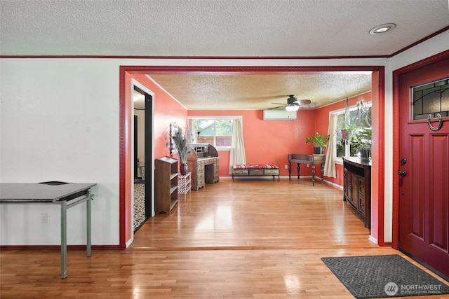 6965E E E, Tacoma, WA 98404 - foyer entrance with a wall mounted air conditioner, a textured ceiling, ornamental molding, light wood finished floors, and a ceiling fan