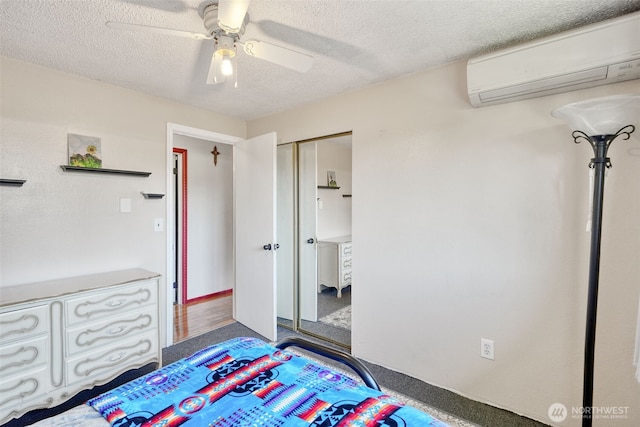 6965E E E, Tacoma, WA 98404 - unfurnished bedroom featuring a wall mounted AC, a textured ceiling, a closet, carpet, and ceiling fan