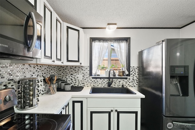 6965E E E, Tacoma, WA 98404 - kitchen with stainless steel appliances, a sink, tasteful backsplash, a textured ceiling, and light countertops