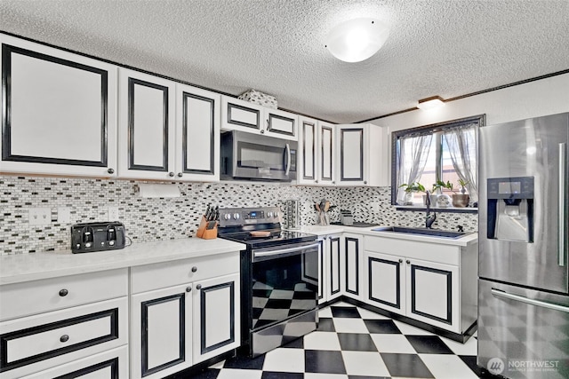 6965E E E, Tacoma, WA 98404 - kitchen featuring appliances with stainless steel finishes, a sink, dark floors, a textured ceiling, and light countertops