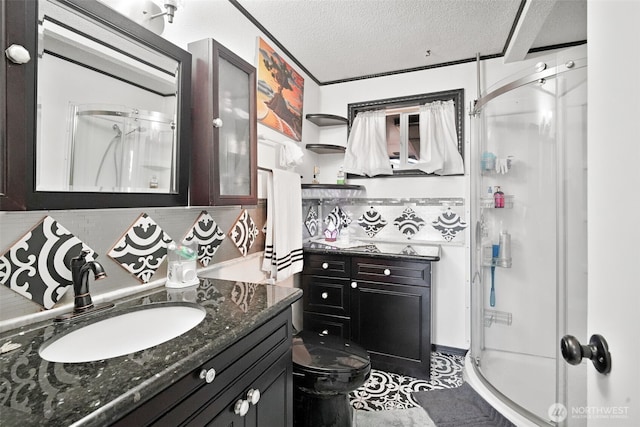 6965E E E, Tacoma, WA 98404 - full bath featuring a stall shower, decorative backsplash, vanity, a textured ceiling, and toilet