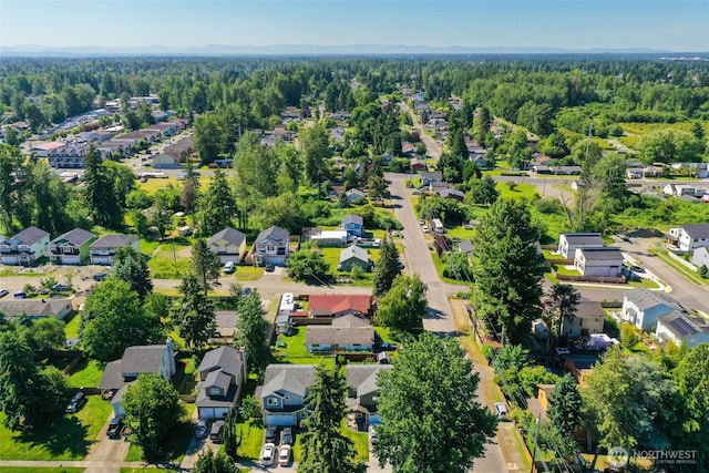 6965E E E, Tacoma, WA 98404 - aerial overview of property's location with nearby suburban area and a forest