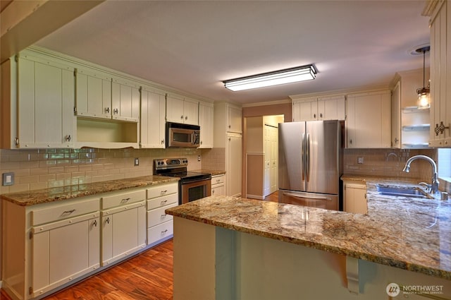 26025 Tronson Rd, Arlington, WA 98223 - kitchen featuring appliances with stainless steel finishes, a sink, a peninsula, open shelves, and dark wood-style floors