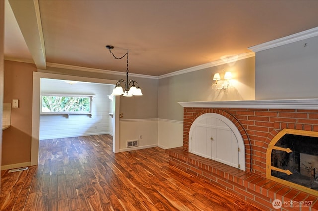 26025 Tronson Rd, Arlington, WA 98223 - unfurnished living room featuring wood finished floors, ornamental molding, a chandelier, and baseboards