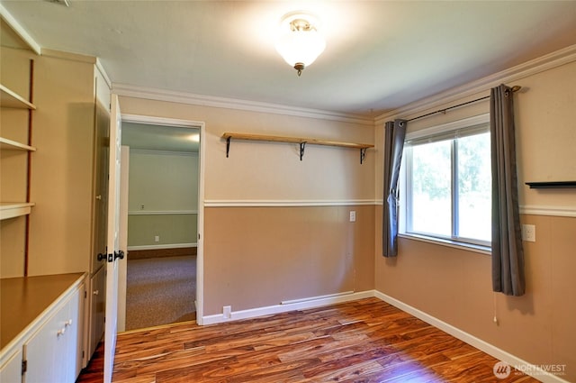 26025 Tronson Rd, Arlington, WA 98223 - unfurnished bedroom with ornamental molding, wood finished floors, a closet, and baseboards