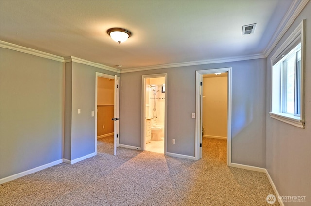 26025 Tronson Rd, Arlington, WA 98223 - unfurnished bedroom featuring crown molding, a walk in closet, carpet floors, ensuite bathroom, and baseboards