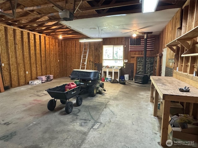 26025 Tronson Rd, Arlington, WA 98223 - garage with a garage door opener and a wood stove
