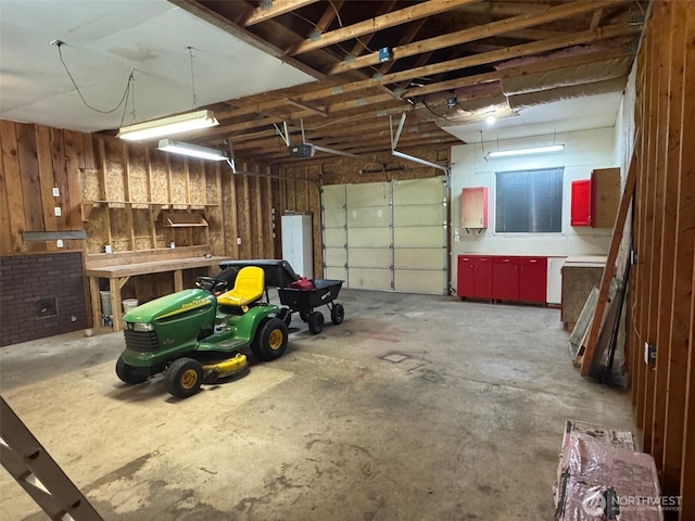 26025 Tronson Rd, Arlington, WA 98223 - garage featuring a garage door opener and wood walls