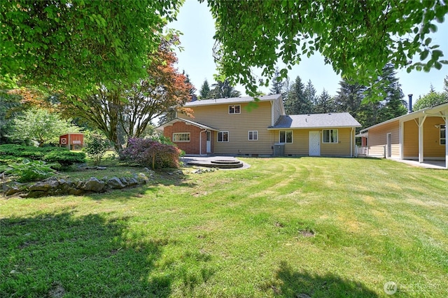 26025 Tronson Rd, Arlington, WA 98223 - back of property featuring a lawn, crawl space, and central AC unit